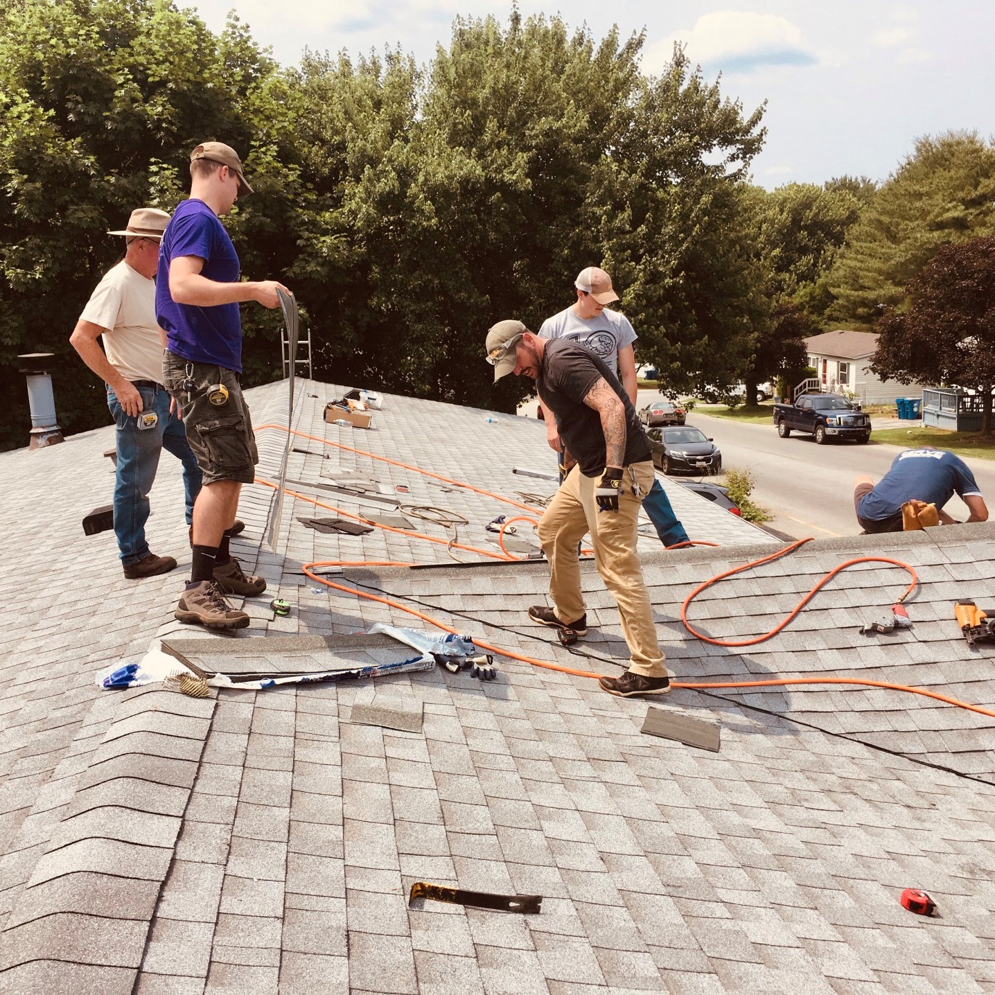 volunteers-from-a-church-work-on-fixing-a-roof-for